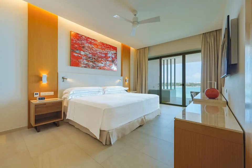 Presidential Suite oceanfront king bedroom with balcony doors at Barceló Maya Riviera.