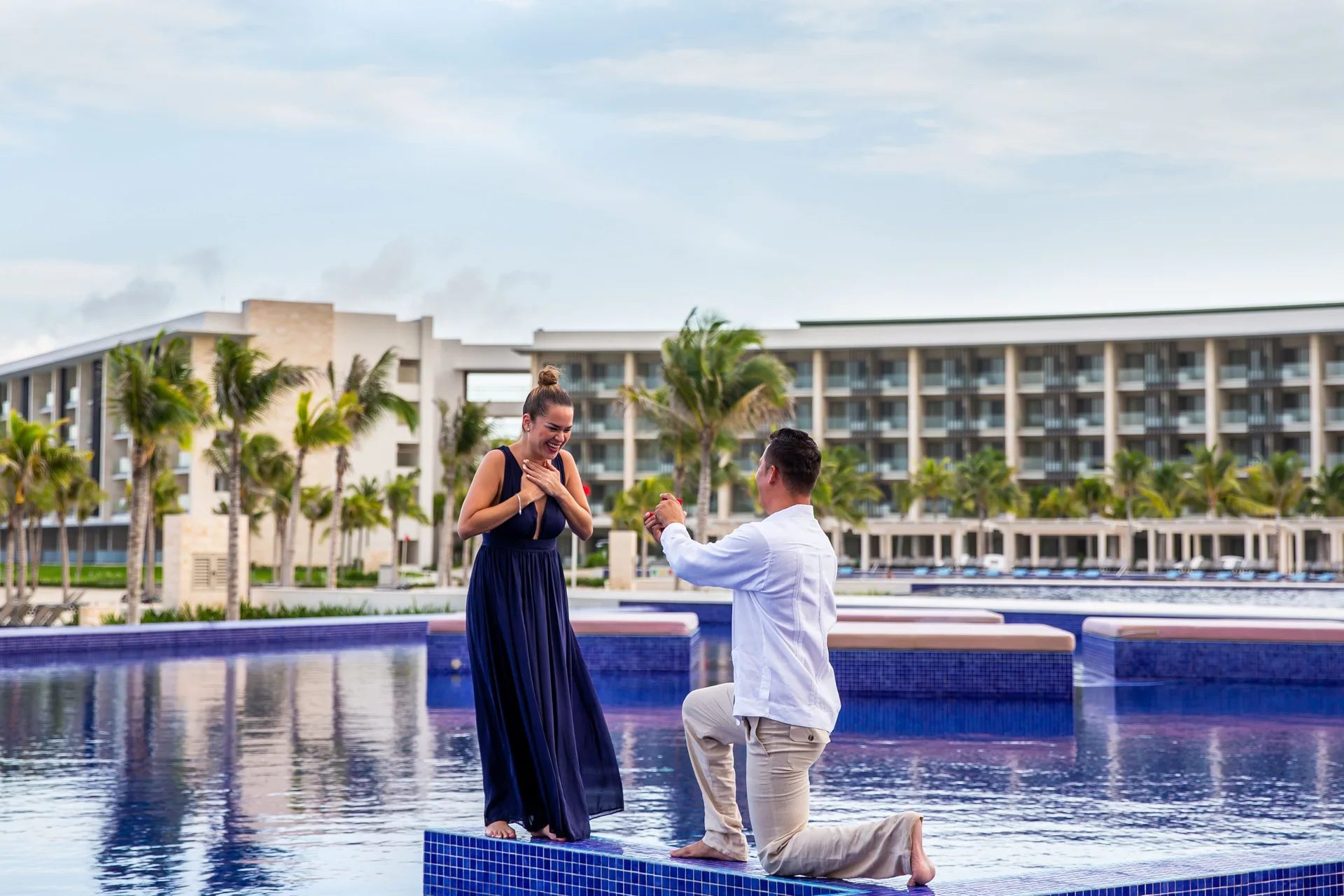 Poolside marriage proposal on a tiled platform at Barceló Maya Riviera.