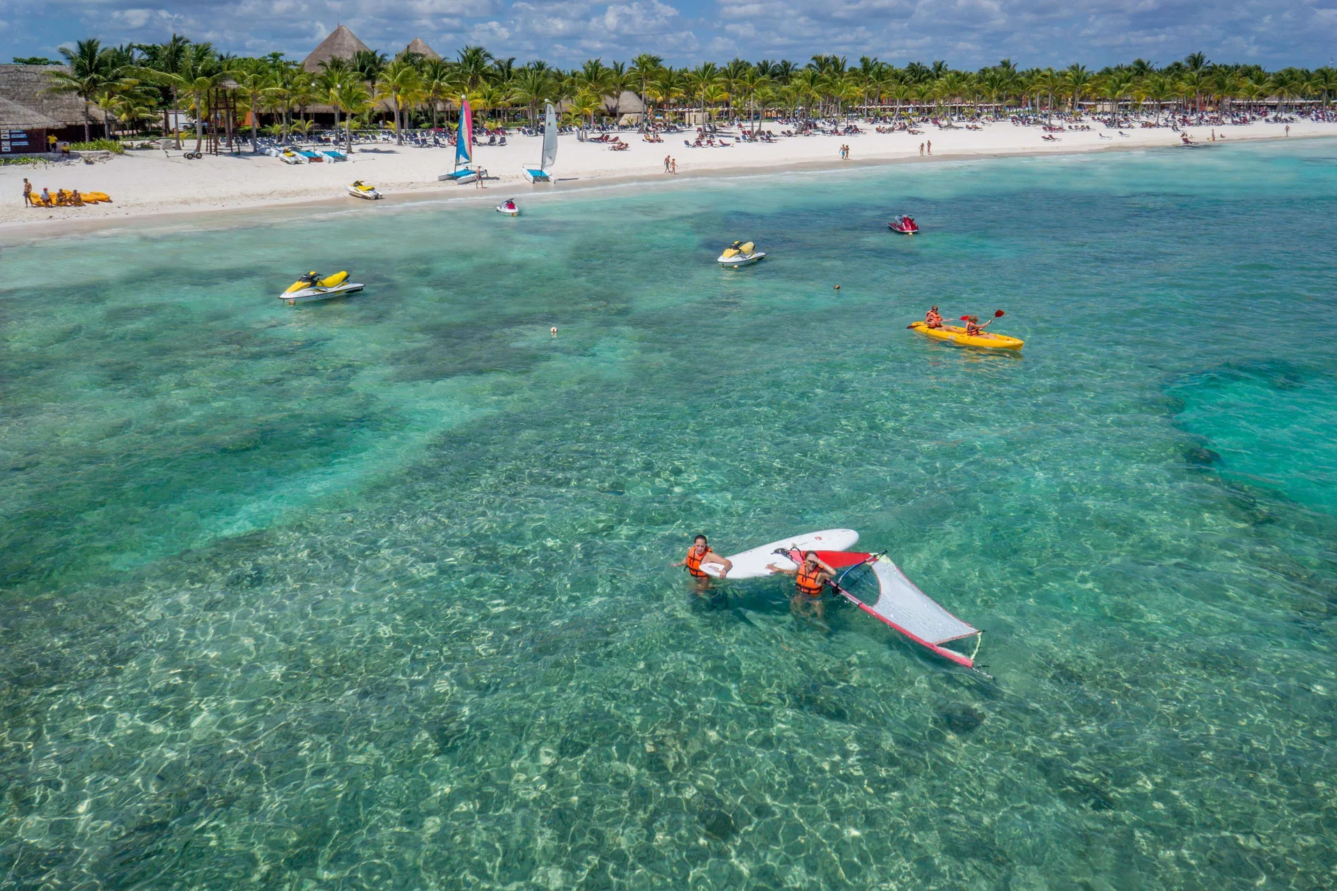 Clear water activities with kayaks and small boats off Barceló Maya Tropical.