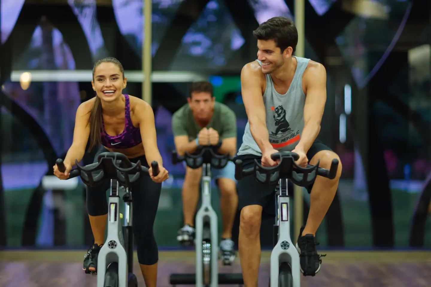 Guests riding stationary bikes in a fitness class at Barceló Maya Tropical.