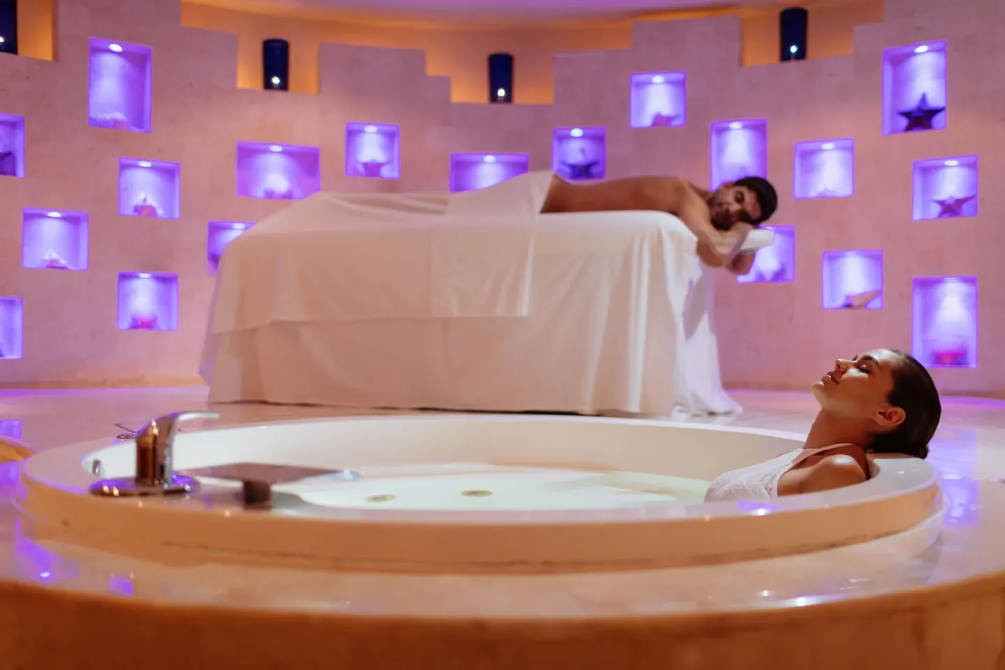 Spa tub and treatment bed in a softly lit spa room at Barceló Maya Tropical.