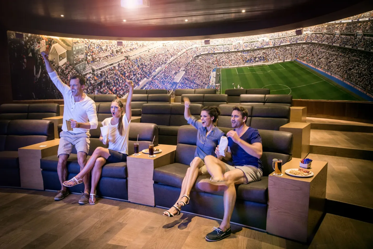 Guests watch a soccer match in theater seating at Barceló Maya Tropical.