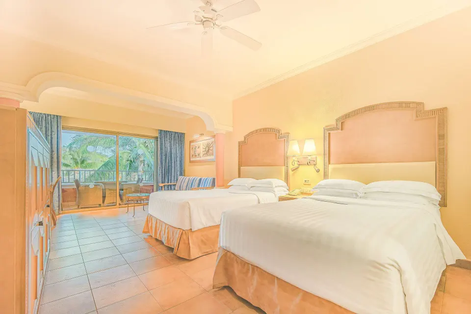 Junior Suite Oceanfront room with two beds and balcony at Barceló Maya Tropical.