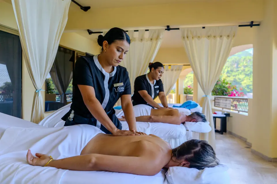 Two guests receiving massages on an open-air terrace at Barceló Puerto Vallarta.