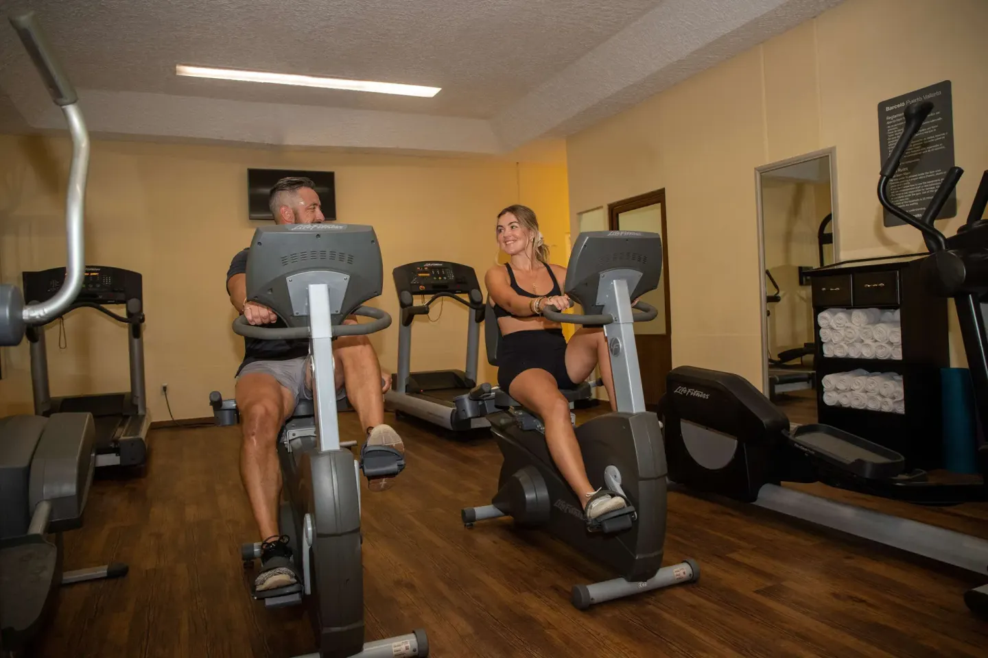 Guests ride stationary bikes in the fitness center at Barceló Puerto Vallarta.