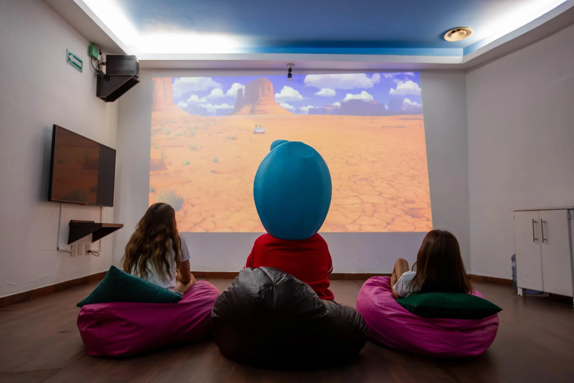 Children watching a projected movie from beanbag chairs at Barceló Puerto Vallarta.