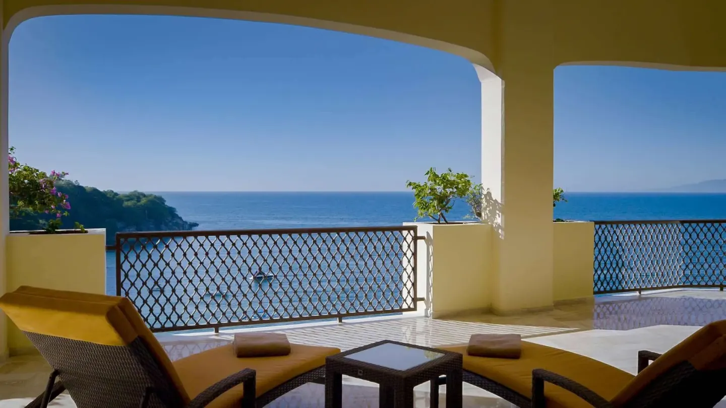 Covered terrace with loungers facing the ocean at Barceló Puerto Vallarta.