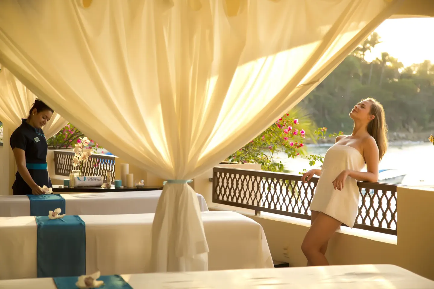Outdoor spa massage beds with draped curtains at Barceló Puerto Vallarta.