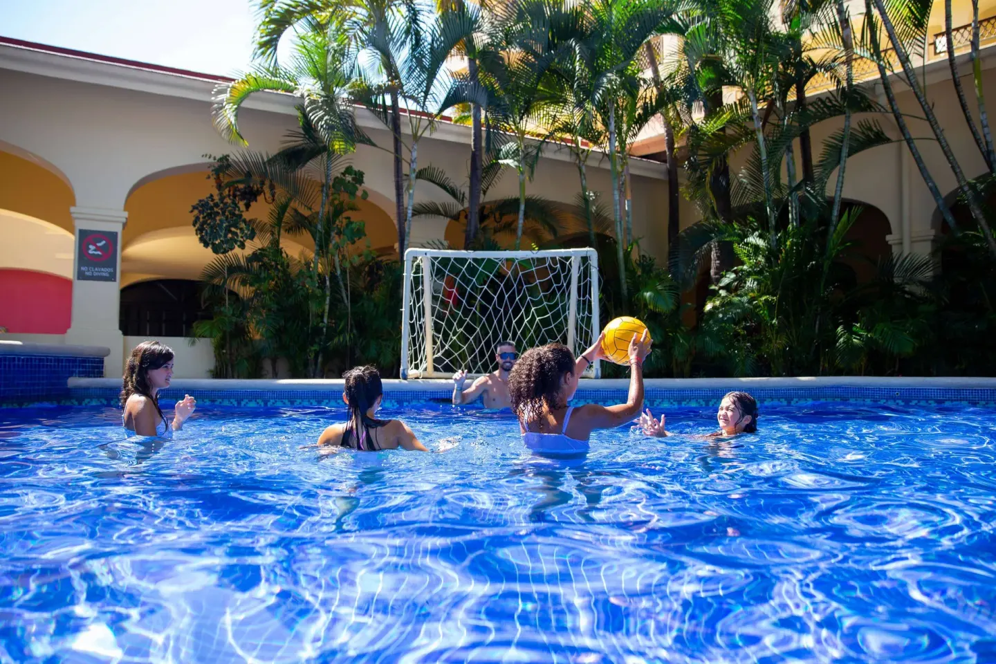 Guests playing water polo in the pool at Barceló Puerto Vallarta.