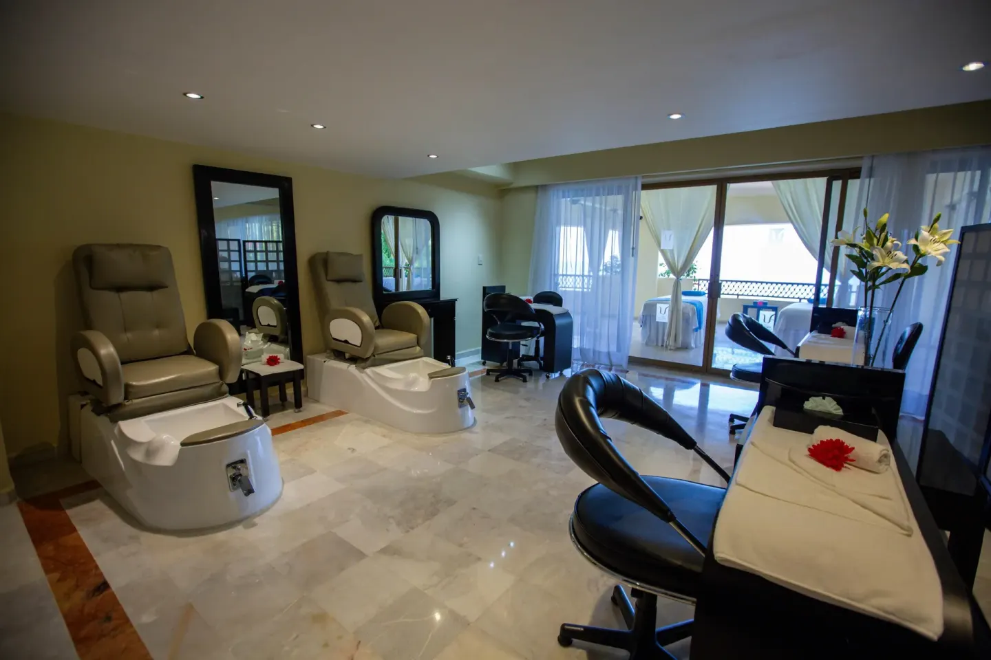 Spa pedicure room with treatment chairs and manicure stations at Barceló Puerto Vallarta.