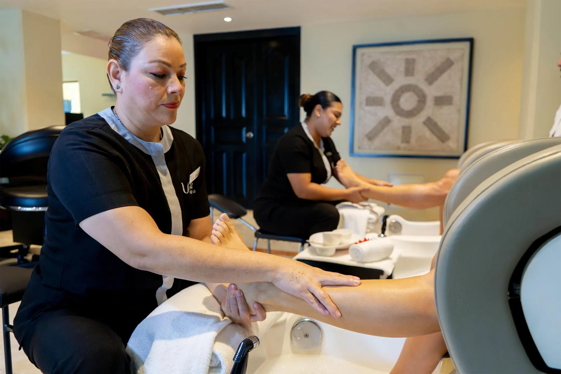 Spa therapists provide pedicure treatments in a salon at Barceló Puerto Vallarta.