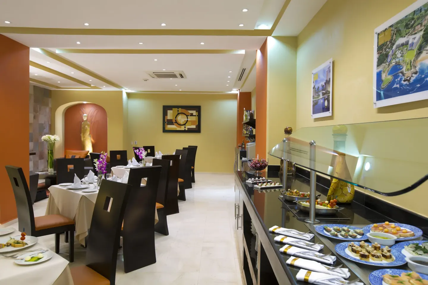 Small dining room with set tables and a buffet counter at Barceló Puerto Vallarta.