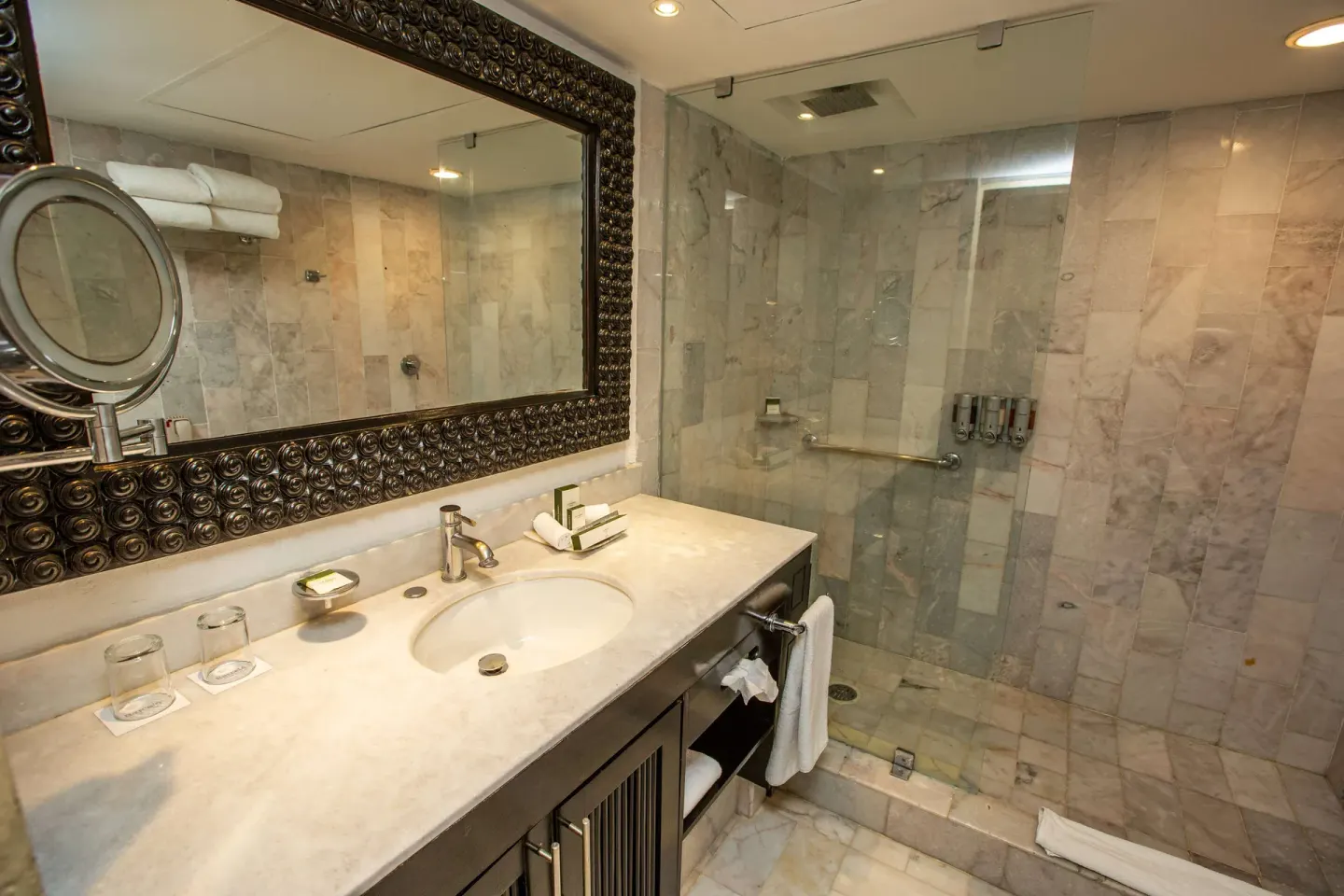 Deluxe Suite bathroom with marble vanity and walk-in shower at Barceló Puerto Vallarta.