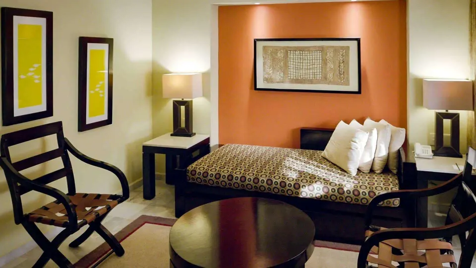 Deluxe Suite lounge area with daybed, chairs and round table at Barceló Puerto Vallarta.