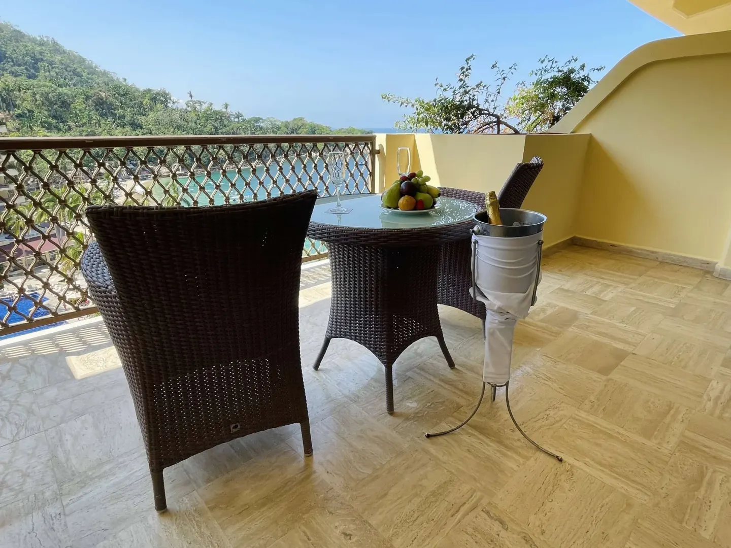 Family Room Premium Level balcony with wicker chairs and table at Barceló Puerto Vallarta.