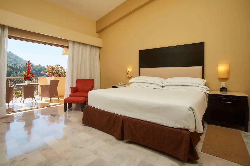 Family Room Premium Level king bed and balcony at Barceló Puerto Vallarta.