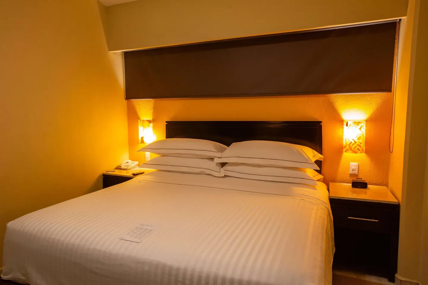 Family Room Premium Level bed with warm bedside lighting at Barceló Puerto Vallarta.