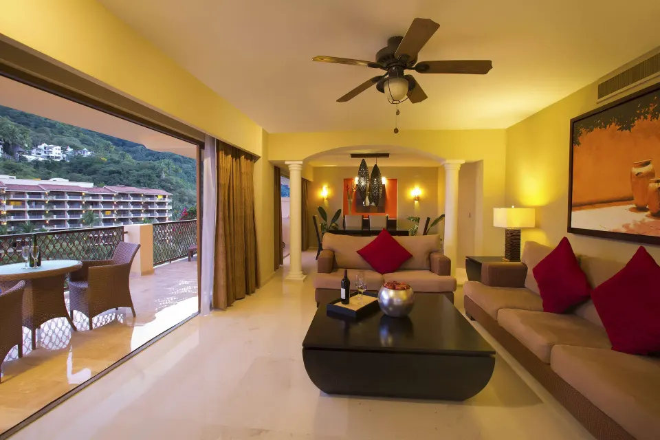 Grand Master Suite living room opening to a furnished balcony at Barceló Puerto Vallarta.