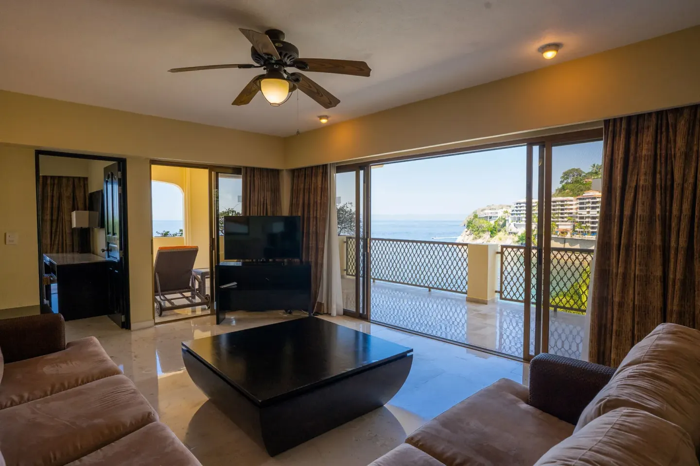 Grand Master Suite living room with ocean-view balcony at Barceló Puerto Vallarta.