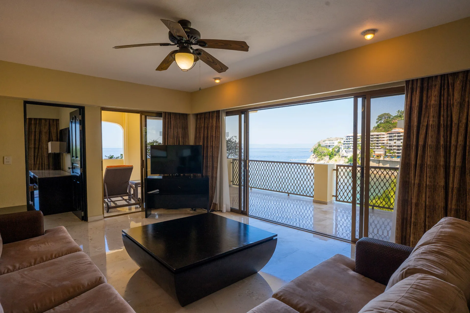 Grand Master Suite living room with ocean-view balcony at Barceló Puerto Vallarta.