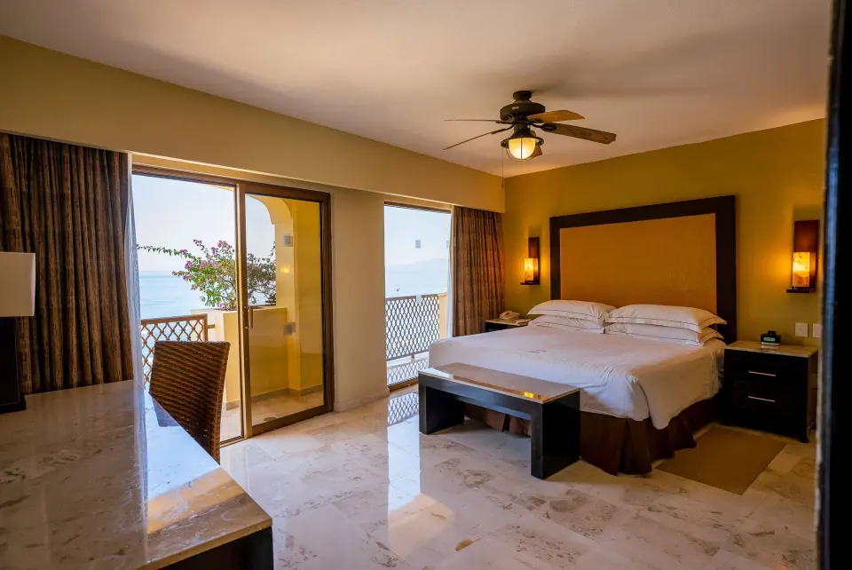 Master Suite king bedroom with balcony and ocean visible at Barceló Puerto Vallarta.