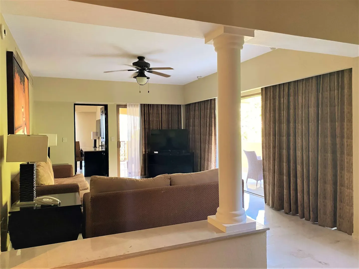 Master Suite living area with column, sofa and balcony curtains at Barceló Puerto Vallarta.