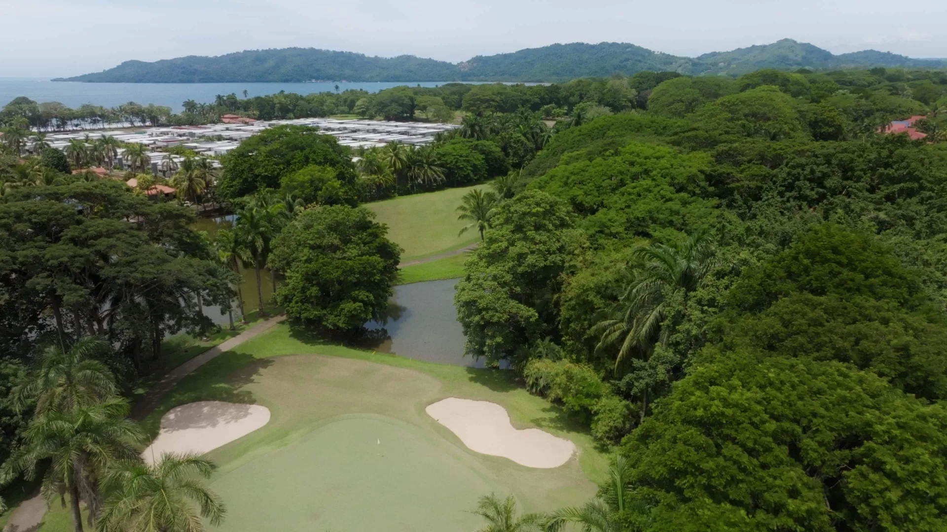 Aerial view of a golf green, sand bunkers, lagoon and coast at Barceló Tambor.