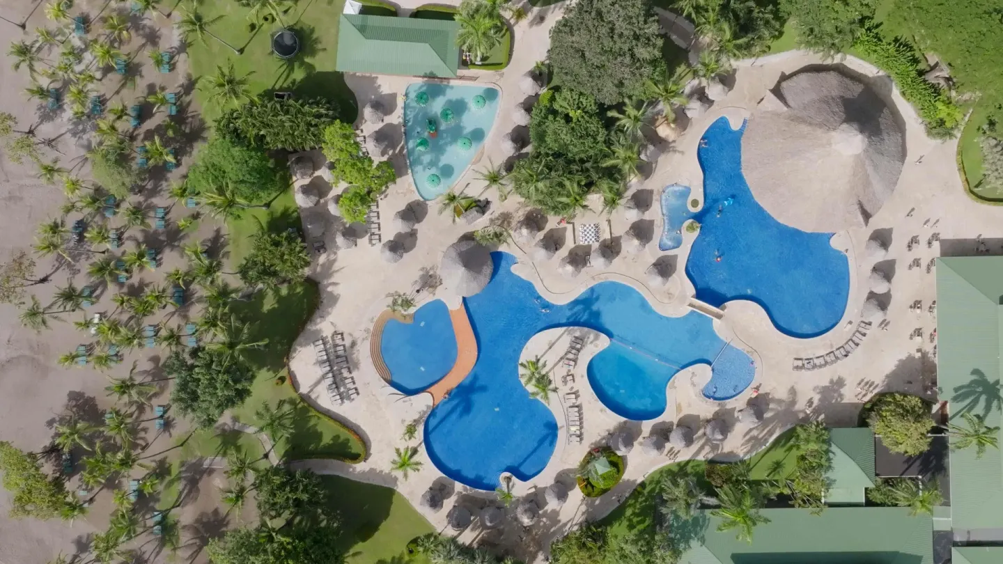 Aerial view of pools, beach palms and resort paths at Barceló Tambor.