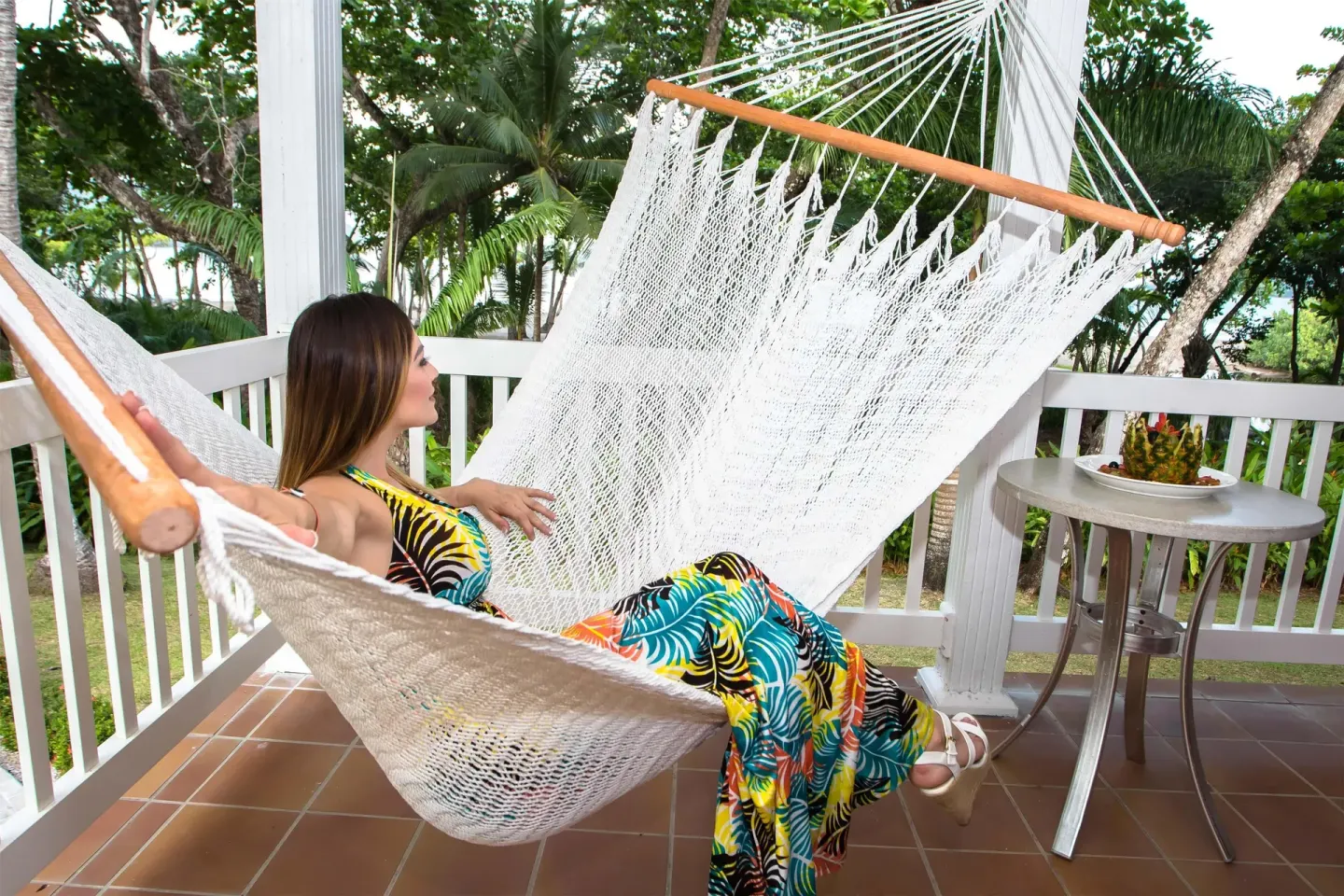 Balcony hammock with a guest relaxing among tropical trees at Barceló Tambor.