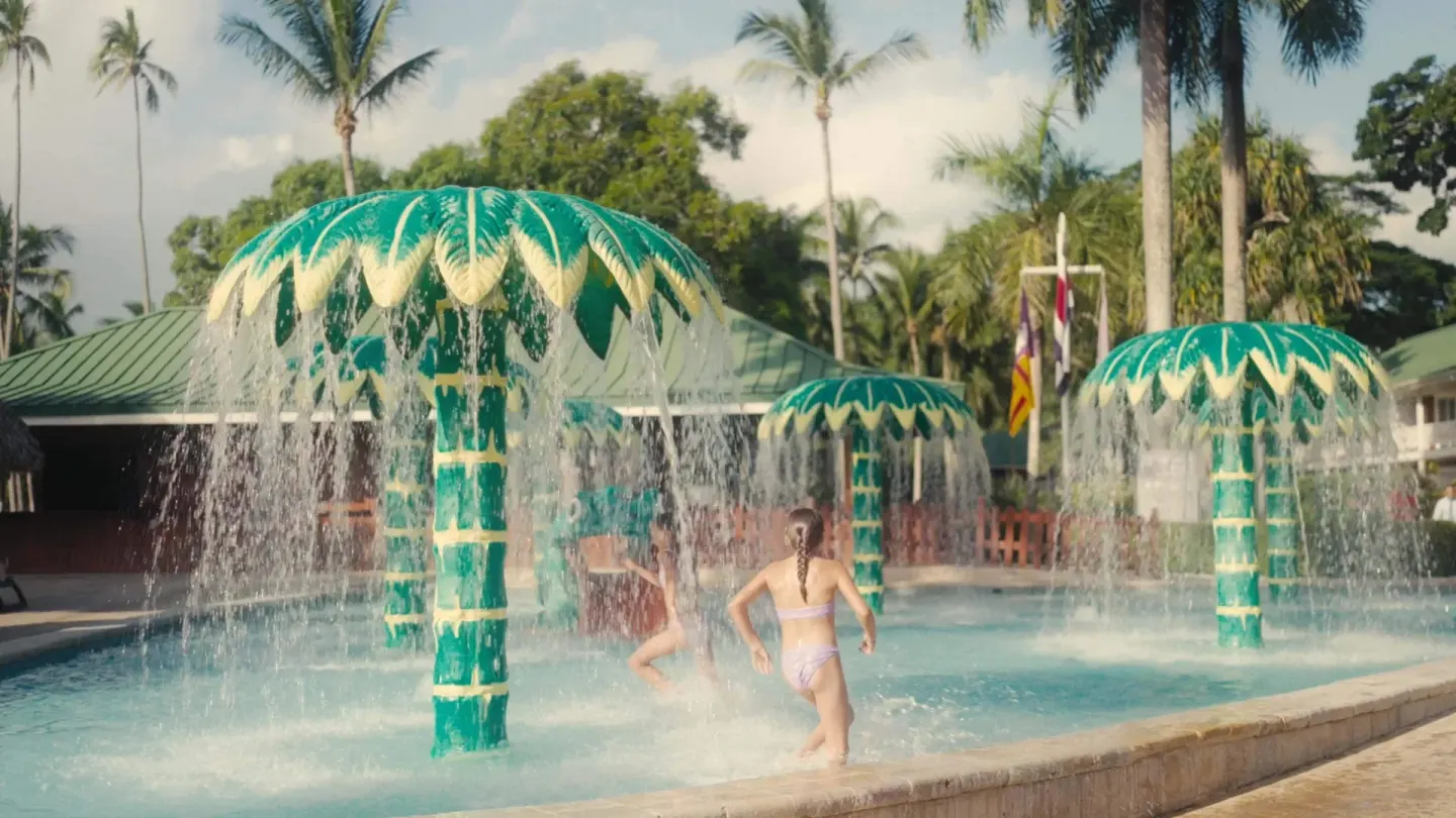 Children running through palm-shaped splash fountains at Barceló Tambor.