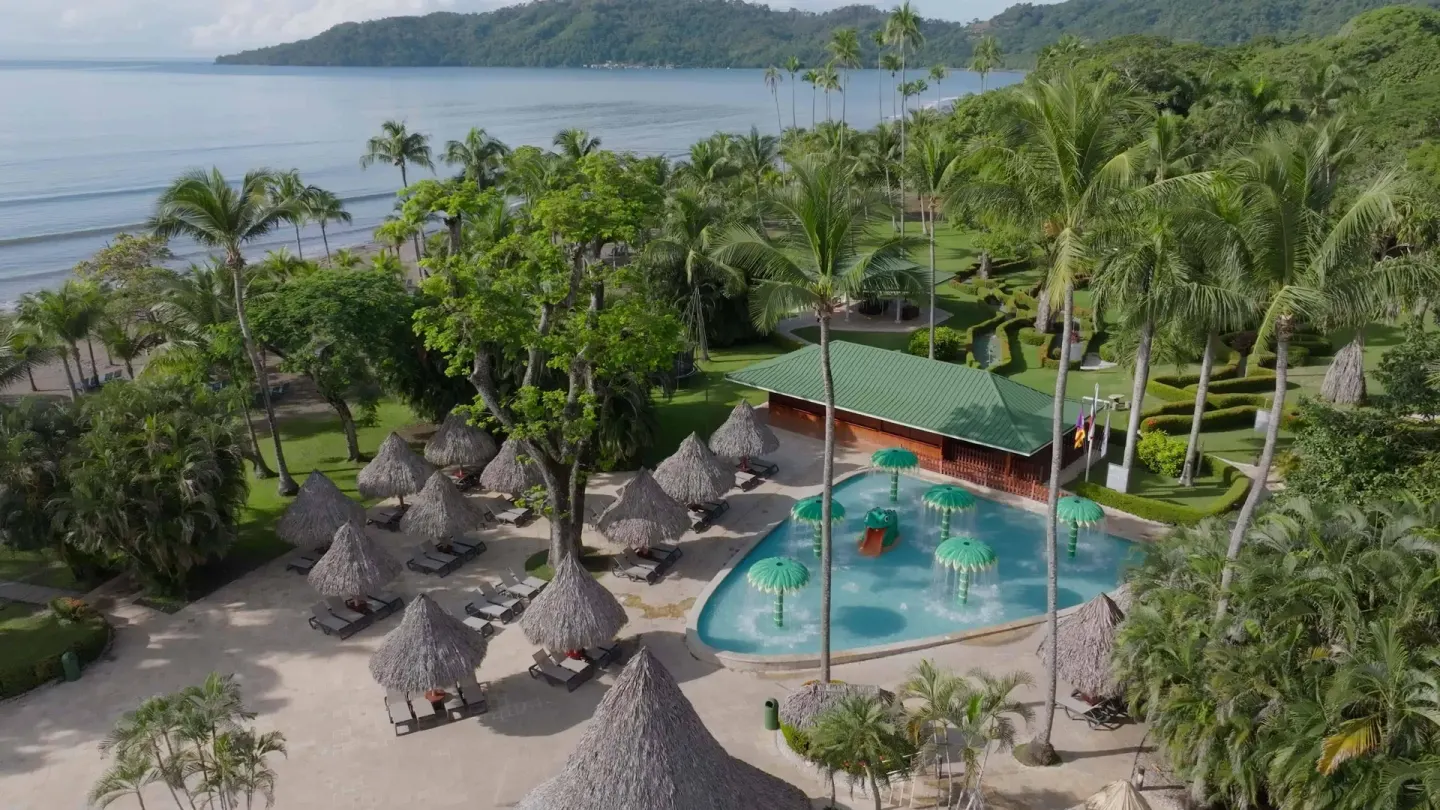 Children's splash pool with palm water features near the beach at Barceló Tambor.