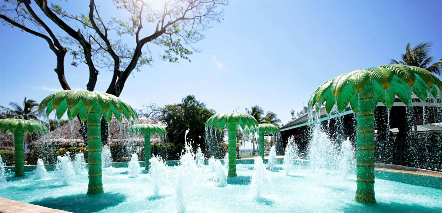 Splash pool with palm-shaped fountains spraying water at Barceló Tambor.