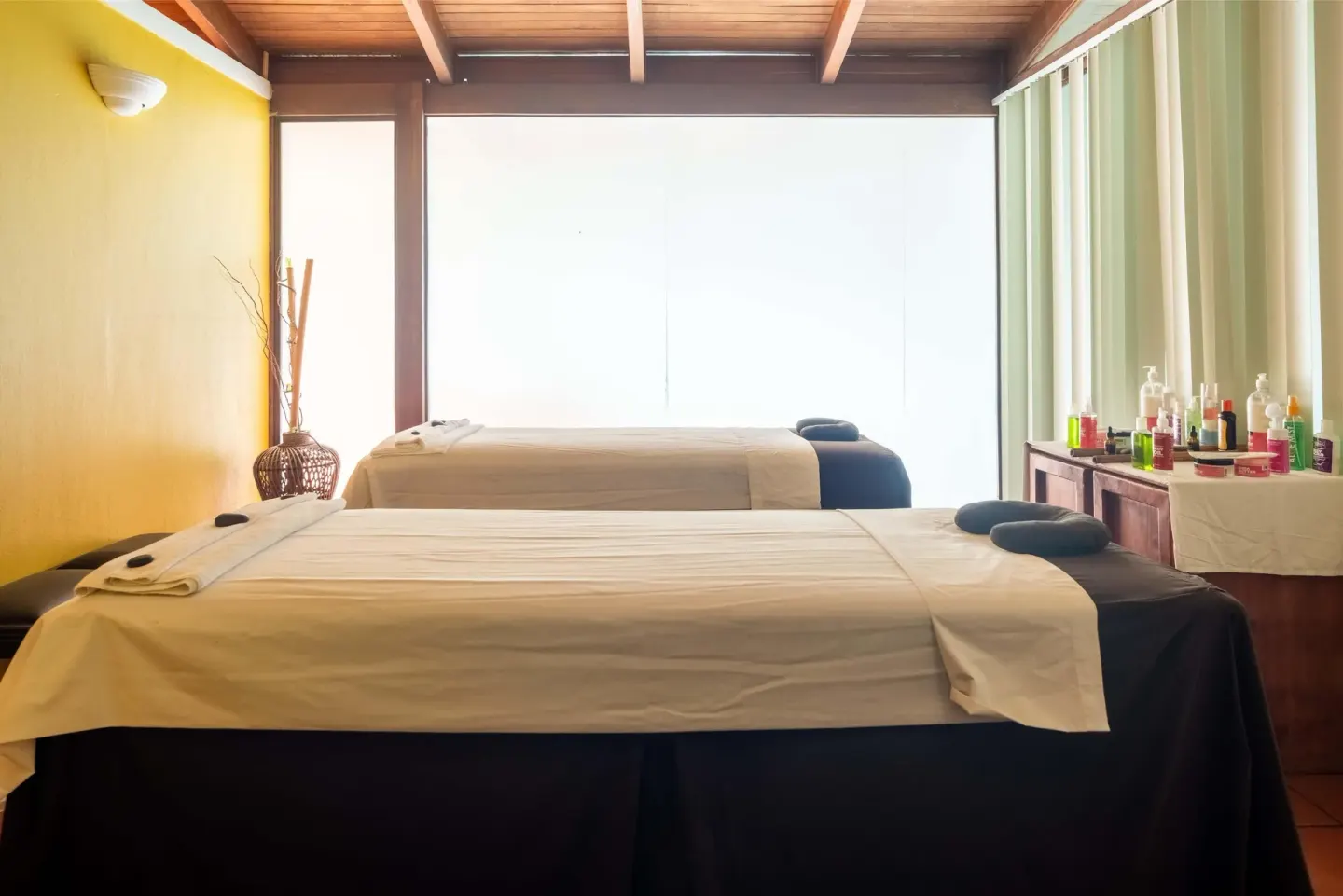 Spa room with two treatment beds and product bottles at Barceló Tambor.