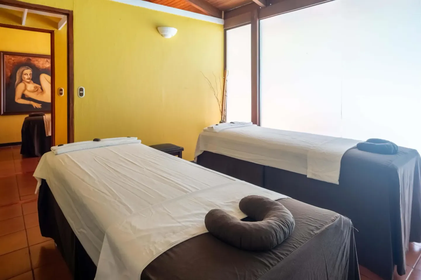Two spa treatment beds in a yellow-walled room at Barceló Tambor.