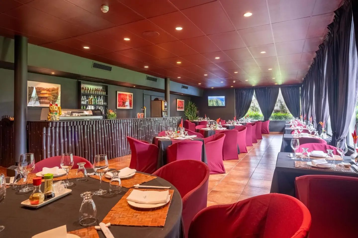 Japanese-style restaurant with red chairs and black drapes at Barceló Tambor.