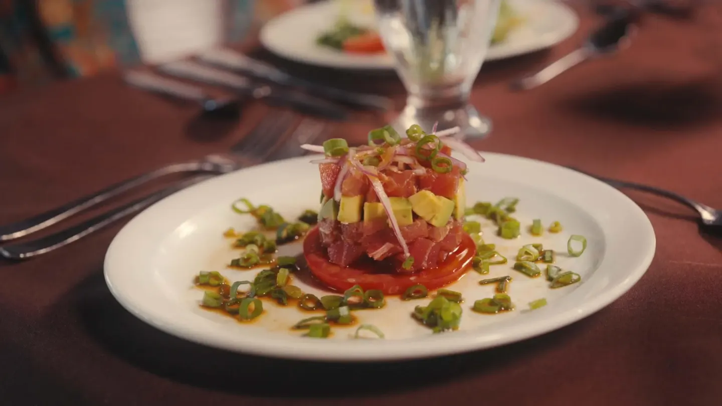 Plated tuna and avocado appetizer on a dining table at Barceló Tambor.