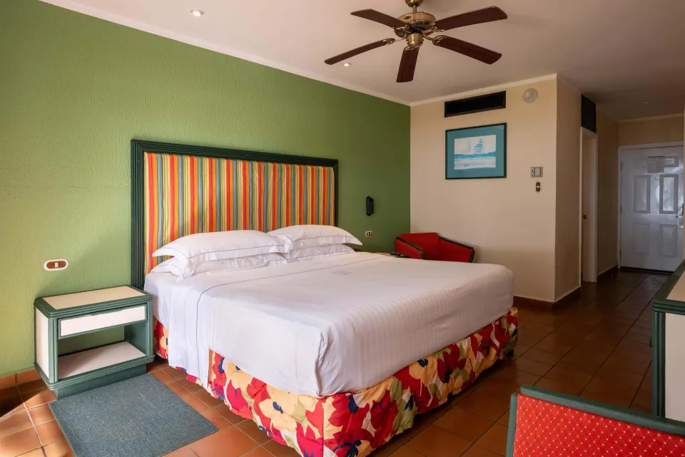 Premium Superior king room with entry area and chair at Barceló Tambor.