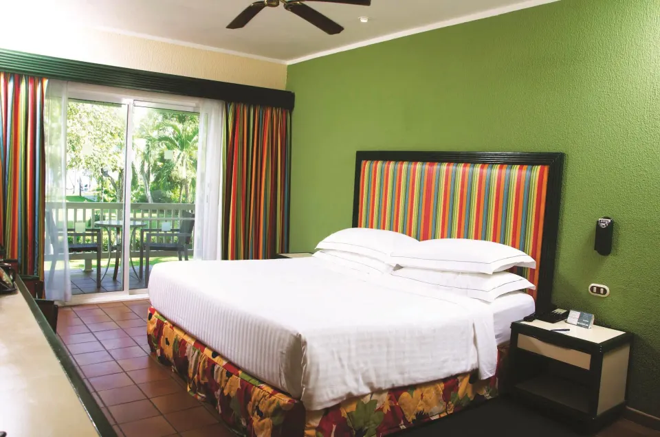 Superior Room with one large bed and balcony doors at Barceló Tambor.