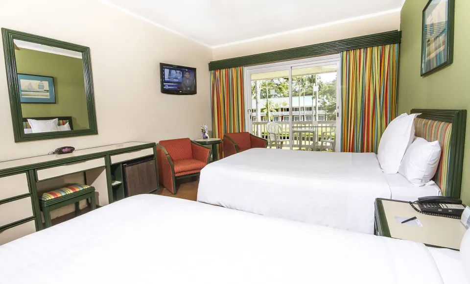 Superior Room with two beds, seating, TV, and balcony at Barceló Tambor.