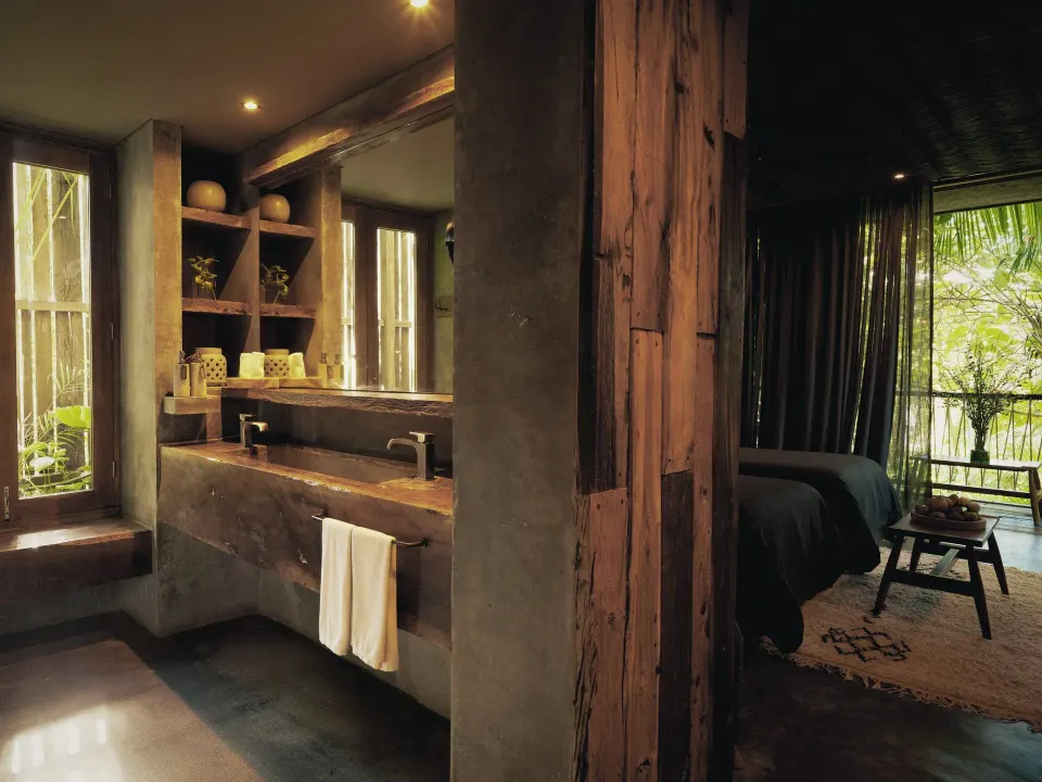 Bathroom vanity opening onto a bedroom and tropical views at BE Destination Tulum