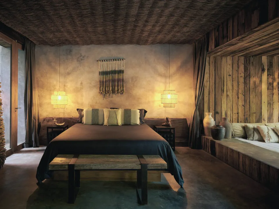 Bedroom with king bed and glass doors opening to a private patio at BE Destination Tulum