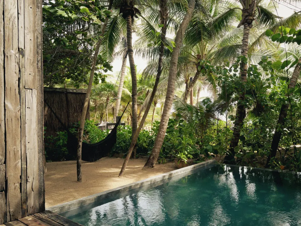 Private plunge pool and hammock surrounded by palms at BE Destination Tulum