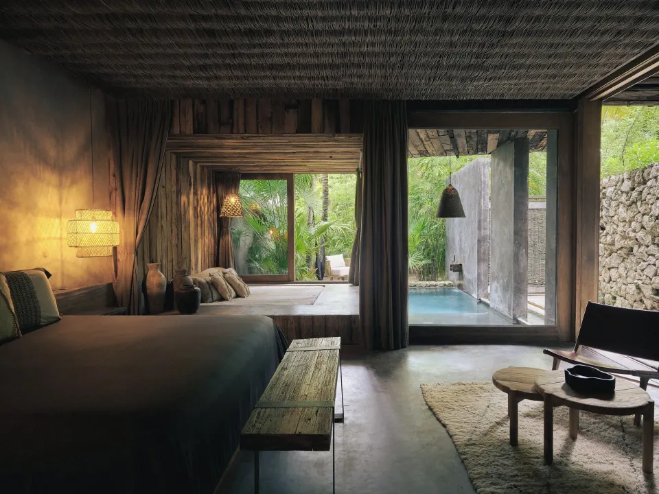 King bed facing private plunge pool and garden at BE Destination Tulum