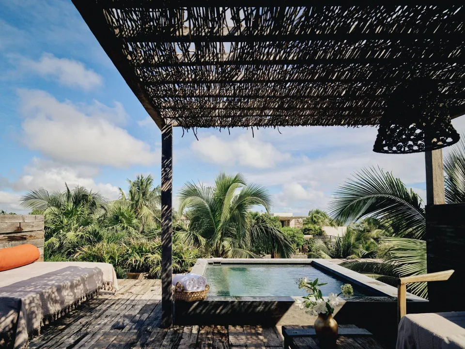 Shaded terrace with a private plunge pool and tropical palms at BE Destination Tulum