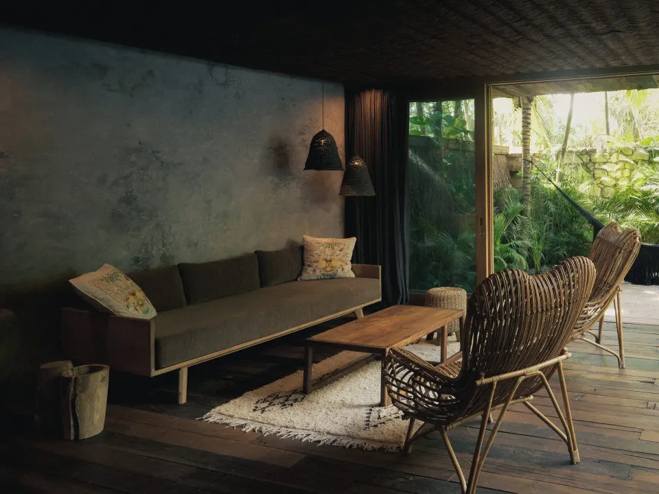 Bright suite living area with balcony and freestanding tub at BE Destination Tulum