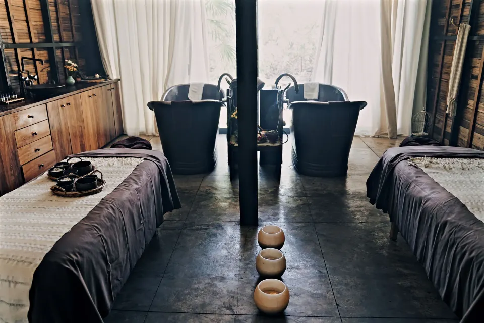 Double treatment room with two tubs and twin massage tables at BE Destination Tulum