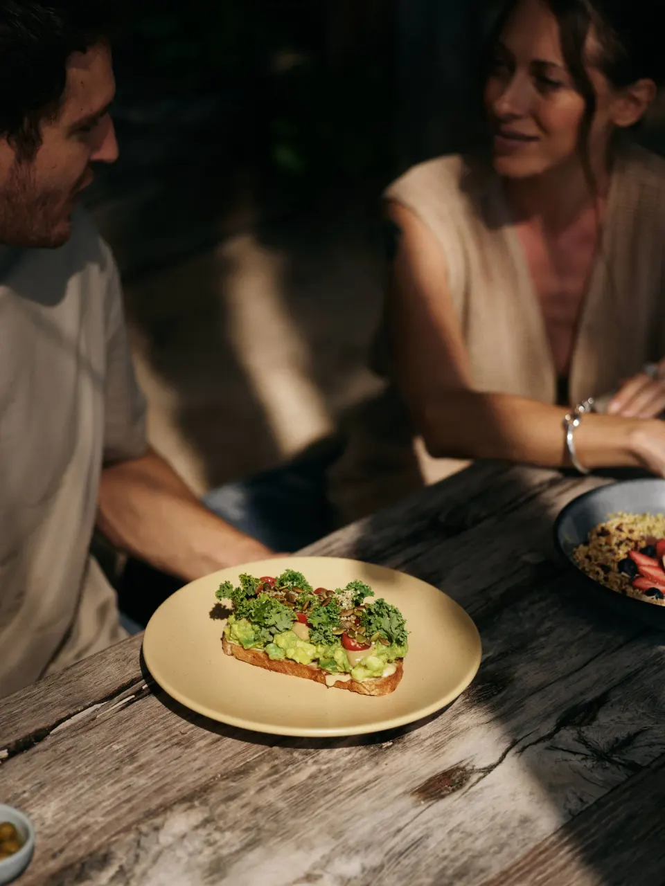 Avocado toast and two guests dining at BE Destination Tulum