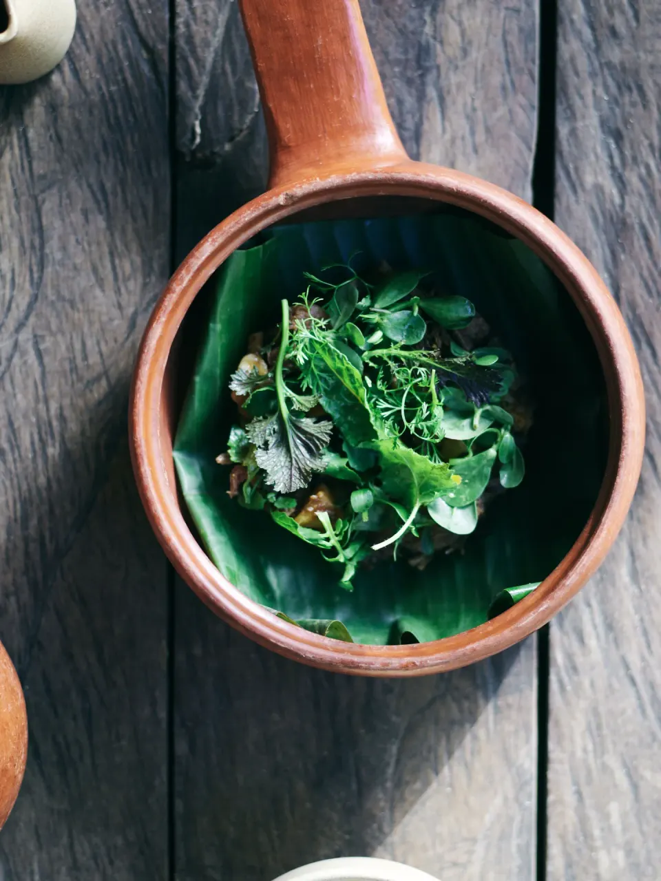 Herb-topped dish in a ceramic pot at BE Destination Tulum