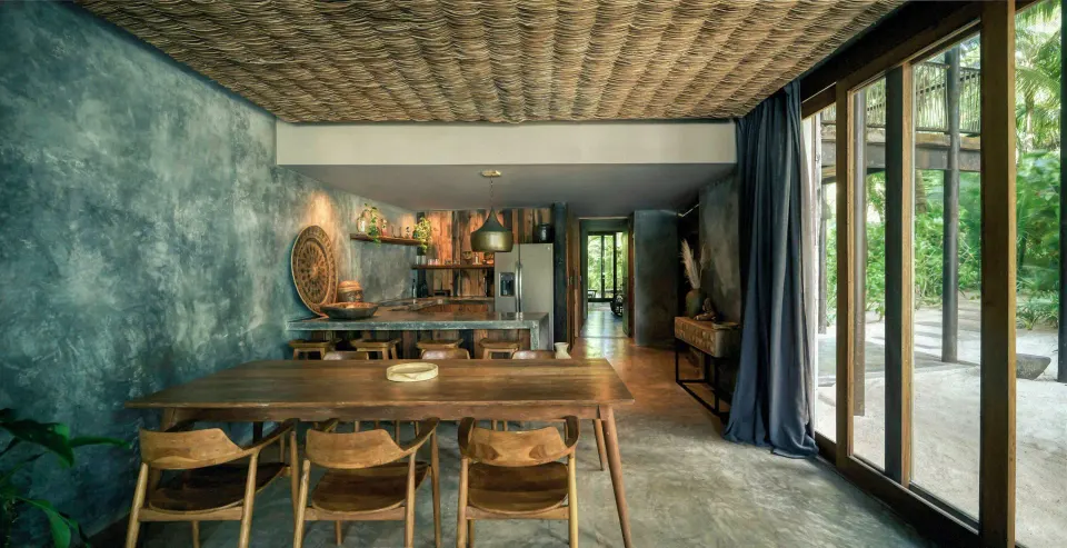 Premier Suite Oceanfront dining area and kitchenette opening to terrace at BE Destination Tulum