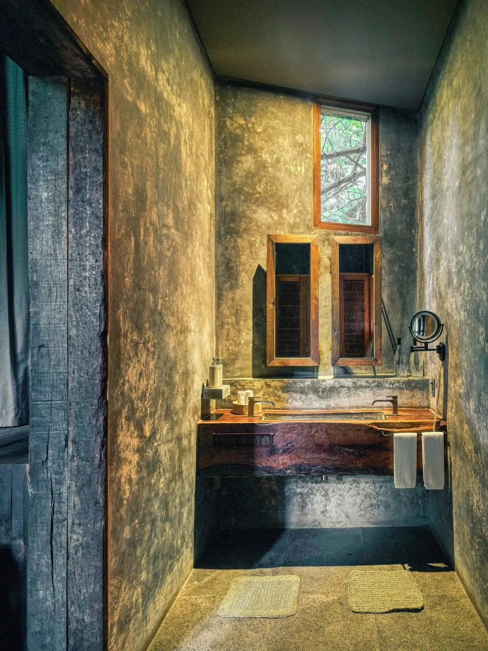 Bathroom vanity with double mirrors and stone sink in a Premier Palm Suite at BE Destination Tulum